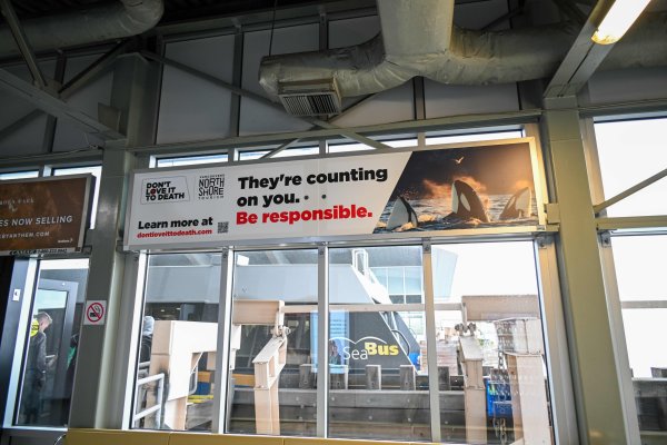 A sign at the SeaBus Terminal has a photo of orcas and reads: They're counting on you. Be responsible.